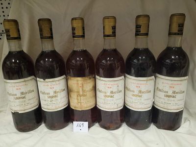 six bottles of wine are lined up in a row on a table