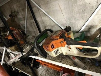 une tronçonneuse et d'autres outils dans un garage