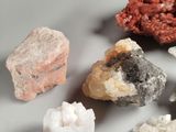 many different types of rocks and crystals on the table