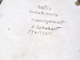 a white plate with writing on it sitting on a table