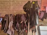 many pairs of pants hanging on a rack in a garage