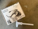 a box with a pair of scissors in it on the floor