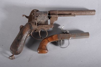 a small wooden gun with a wooden handle on a white surface