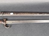 an old knife and a small knife on a gray surface