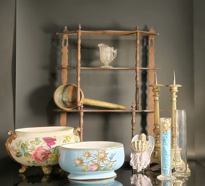 a shelf that has a bowl, candle, and other items on it