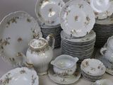 a lot of plates and cups and saucers on the table