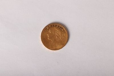 a close up of a coin on a white surface
