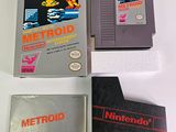three nintendo game cartridges sitting on top of each other on a table
