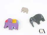 two elephants that are next to each other on a white surface