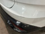 a close up of a car ' s bumper with a denting on it