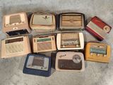many old radio ' s sitting on the floor next to each other