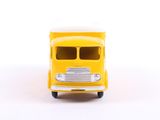 a yellow toy bus that is on a white surface