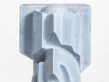 marble sculpture of a block of marble on a white pedestal