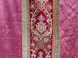 a close up of a pink and gold dress on a mannequin mannequin