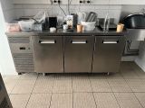 a stainless steel counter with a bunch of dishes on it