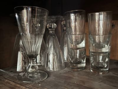 four glasses sitting on a table next to each other
