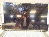 a picture of a man taking a picture of a broken laptop