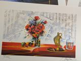 three paintings of flowers in a vase on a table