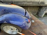 a blue car that is parked on the side of the road