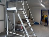 a picture of a ladder in a garage with the door open