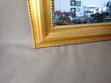 a picture of a gold frame with a clock in it