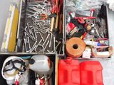 many different tools in a metal box on the floor
