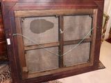 an old wooden cabinet with a glass door