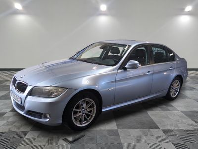 2011 bmw 3 series sedan in a showroom with a checkered floor