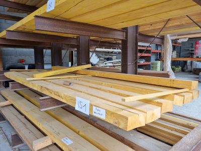 several pieces of wood are stacked on top of each other in a warehouse