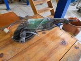someone is using a sander to polish a wooden table in a workshop