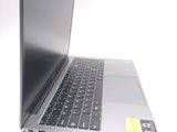 a silver laptop with a black keyboard on a white surface