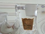 a glass candle holder that has a label on it