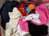 a suitcase full of clothes that is sitting on the floor