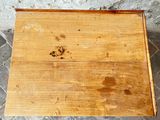 a small wooden box with a brown stain on it