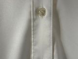 a close up of a white shirt with buttons on it