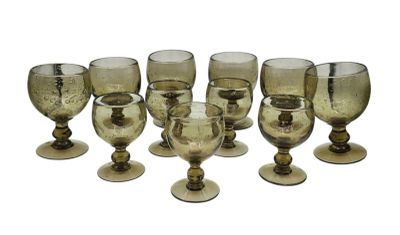 six wine glasses sitting next to each other on a table