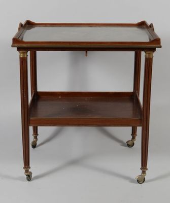 a small wooden table with a glass top on wheels