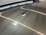 a remote control sitting on top of a shiny car