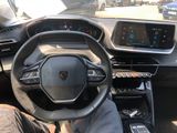 someone is sitting in the driver ' s seat of a car with their feet on the steering wheel