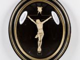 a black and gold clock with a crucifix on it
