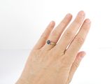 a woman ' s hand with a diamond ring on it