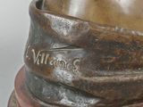 a statue of a man with a hat on top of a table