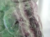 a close up of a green and purple marble statue