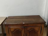 a small table and a small cabinet in a room