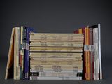 several books stacked on top of each other on a table
