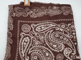 a brown banda with a white paisley pattern on it
