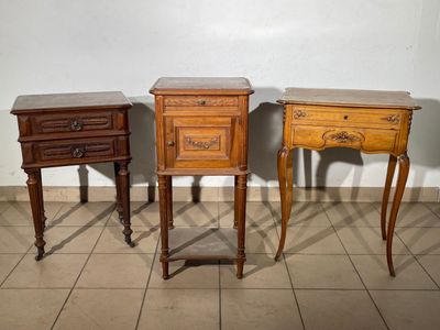 three wooden tables with drawers on them in a room