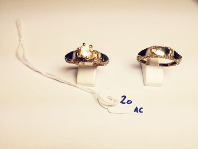 pair of gold tone rings with black and white stones on them