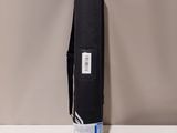 the back of a black bag sitting on top of a white table