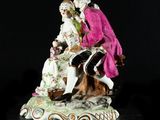 a figurine of a man and a woman sitting on a bench